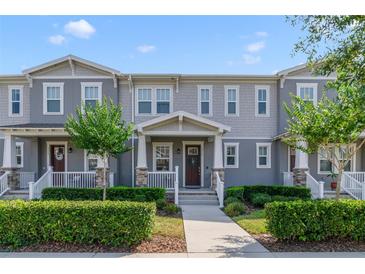 Charming two-story townhome with well-maintained landscaping and inviting front porch at 2224 Celebration Blvd, Celebration, FL 34747