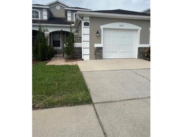 Charming single-Gathering home featuring a well-maintained lawn and attached two-car garage at 3244 River Branch Cir, Kissimmee, FL 34741
