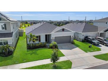 Charming single-Gathering home with manicured lawn, gray paint, and inviting curb appeal at 685 Overpool Ave, Davenport, FL 33896