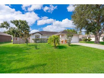 Charming single-story home with well-manicured lawn, mature trees, and lush landscaping at 812 Adour Dr, Kissimmee, FL 34759