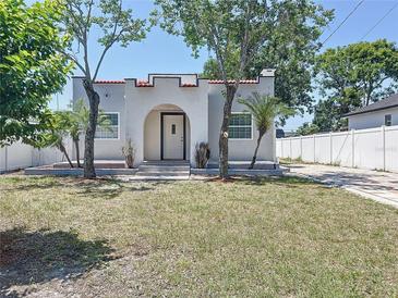 Charming single Gathering home with a well-maintained lawn and arched entryway at 2409 E Magnolia St, Lakeland, FL 33801