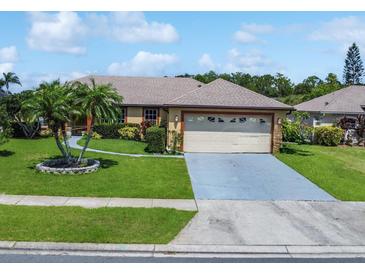 Charming single-story home with a well-manicured lawn and a two-car garage at 3811 Gator Bay Ln, St Cloud, FL 34772