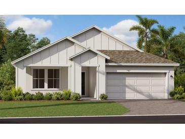 Charming single-Gathering home featuring white siding, a two-car garage, and a neatly landscaped front yard at 4053 Redbridge Loop, Davenport, FL 33837