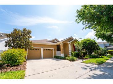 Charming single-Gathering home featuring a two-car garage, manicured landscaping, and a welcoming entrance at 8835 Abbey Leaf Ln, Orlando, FL 32827
