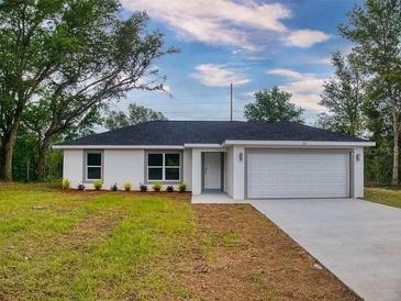 Charming single-Gathering home featuring a two-car garage and a well-maintained front lawn at 14512 Sw 25Th Lane, Ocala, FL 34481