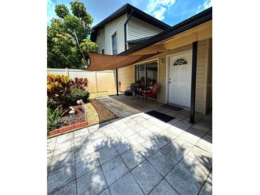 Inviting front porch with seating area and shade cover, perfect for relaxing outdoors at 1844 Townhall Ln # 1844, Orlando, FL 32807