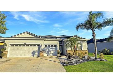 Stunning two-car garage home with a well-manicured lawn and tropical landscaping at 2164 Crosston Cir, Orlando, FL 32824