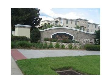 Stone sign for Verona Ridge community with manicured landscaping and multi-story buildings in the background at 3001 Greystone Loop # 106, Kissimmee, FL 34741