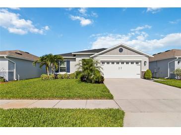 Charming single-story home with well-manicured lawn and two-car garage at 3211 Sweet Acres Pl, St Cloud, FL 34772