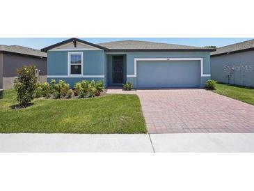 Charming single-story home featuring a well-maintained lawn and a brick-paved driveway at 3214 Viceroy Ct, Kissimmee, FL 34759