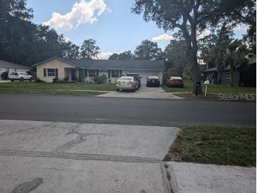 Ranch-style home with a two-car garage and mature trees at 4345 Old Colony Rd, Mulberry, FL 33860