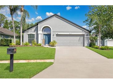 Charming home featuring a well-manicured lawn, attached garage, and inviting front entrance at 501 Dunoon St, Ocoee, FL 34761