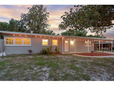 Charming single story home with welcoming front porch and a well-maintained yard under a beautiful sunset at 807 E Airport Blvd, Sanford, FL 32773