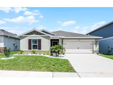 Charming single-story home featuring a well-manicured lawn and a two-car garage at 1139 Seedorf Dr, Winter Haven, FL 33881