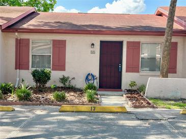 Charming single story house with painted facade, decorative shutters, and tidy landscaping at 13 W Marbrisa Way, Kissimmee, FL 34743
