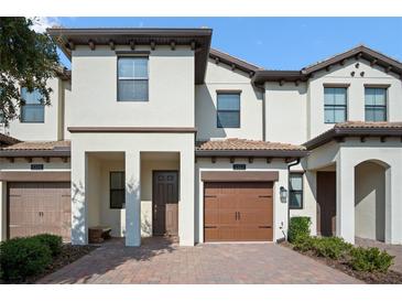 Beautiful two-story townhome featuring a private garage and covered entryway at 1312 Royal St George Blvd, Davenport, FL 33896