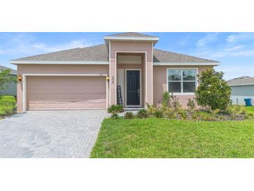 Inviting single-story home featuring a brick driveway and a welcoming covered entrance at 172 Roseville Dr, Haines City, FL 33844