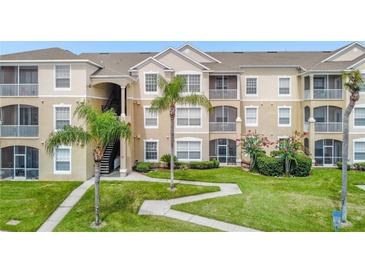 Beautiful condominium building featuring lush landscaping and outdoor living spaces at 2307 Silver Palm Dr # 304, Kissimmee, FL 34747