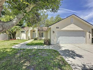 Well-maintained home featuring lush landscaping, a two-car garage, and a classic suburban appeal at 86 Blackberry Creek Dr, St Cloud, FL 34769