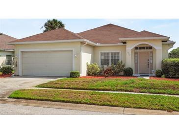 Charming single-story home with a well-maintained lawn and two-car garage at 906 Berwick Dr, Davenport, FL 33897