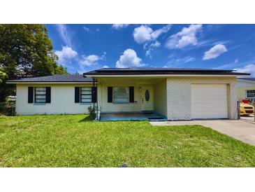 Charming single-story home featuring a well-maintained lawn, covered entry, and attached one-car garage at 2127 Patrick St, Kissimmee, FL 34741
