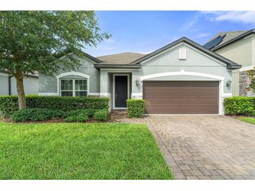 Charming single-story home featuring manicured lawn and a two-car garage at 3424 Middlebrook Pl, Harmony, FL 34773