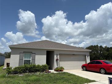 Well maintained home with a neutral color scheme, landscaping and a two-car garage at 3476 Yarian Dr, Haines City, FL 33844