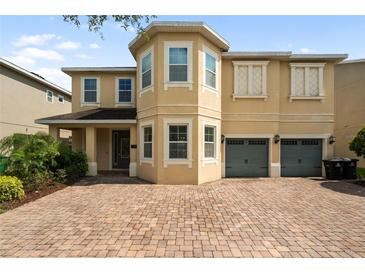 Charming two-story home with a two-car garage and brick paved driveway at 7616 Brookhurst Ln, Kissimmee, FL 34747