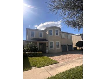 Charming two-story home boasts a well-manicured lawn and a spacious two-car garage at 7616 Brookhurst Ln, Kissimmee, FL 34747