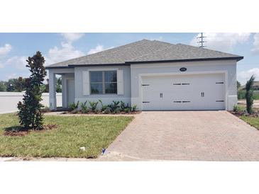 Charming single-story home featuring a two-car garage, well-kept lawn, and inviting curb appeal at 1292 Hilltop Pl, St Cloud, FL 34772
