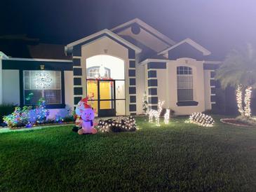 Charming single-Gathering home with holiday decorations and well-maintained landscaping at 216 Boxwood Dr, Davenport, FL 33837