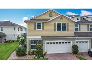 Charming townhouse boasts a two-car garage and well-maintained landscaping at 3603 Sanctuary Dr, St Cloud, FL 34769