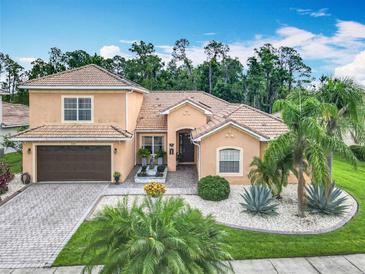 Stunning home with a tile roof, paver driveway, and a lush tropical landscaped yard at 4109 Vessel Ct, Kissimmee, FL 34746