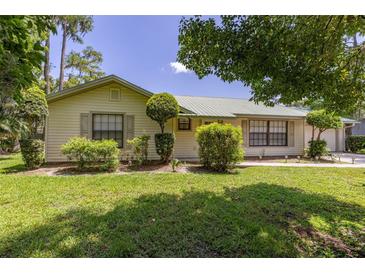 Charming home exterior showcasing lush landscaping, a well-manicured lawn, and natural light at 4307 Oak Ct, St Cloud, FL 34769