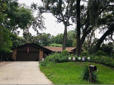 Charming single-story home with a well-manicured front yard and mature trees offering plenty of shade at 655 Vine Ct, Apopka, FL 32703