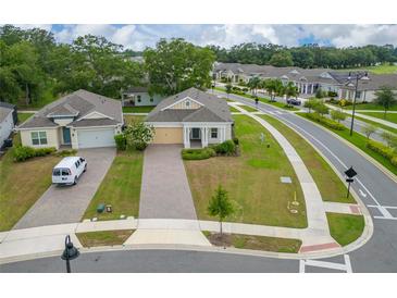 Inviting one-story home featuring manicured lawn and a brick paved driveway, providing great curb appeal at 1598 Whitewood Ct, Kissimmee, FL 34747