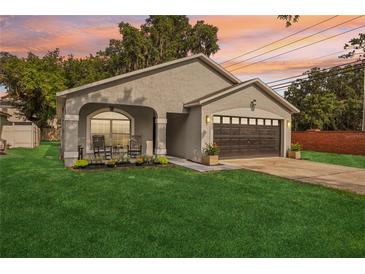 Charming single-Gathering home with a well-manicured lawn and cozy front porch at 2700 Palm Isle Way, Orlando, FL 32829