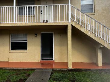 Exterior view of the property featuring a stairway and front entrance at 731 Michigan Ct # 1, St Cloud, FL 34769