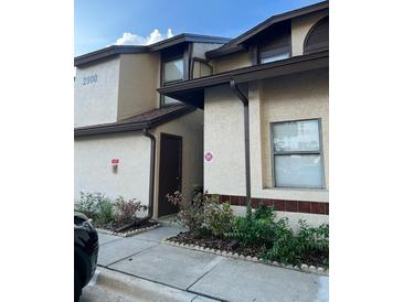 Beige condo with brown trim and landscaping at 2900 S Semoran Blvd # 1, Orlando, FL 32822