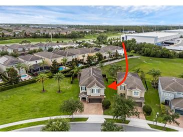 Beautiful aerial view showcasing a well-maintained lawn, mature landscaping, and a community pool at 7541 Marker Ave, Kissimmee, FL 34747