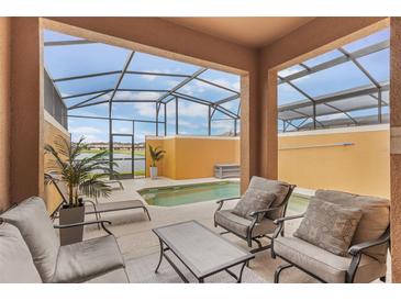 Inviting screened-in lanai with a private pool and comfortable seating area overlooking the water at 8942 Cuban Palm Rd, Kissimmee, FL 34747