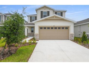 Charming two-story home with a two-car garage and well-maintained landscaping at 208 Flag Lilly Ln, Umatilla, FL 32784