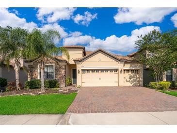 Charming single-story home with brick driveway, manicured lawn, and lush landscaping at 2736 Atherton Dr, Orlando, FL 32824