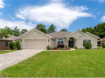 Charming single-story home with well-manicured lawn and a brick driveway at 6644 Sw 179Th Court Rd, Dunnellon, FL 34432