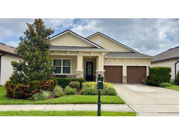Charming one-story home with a well-manicured lawn, complemented by a two-car garage and covered front porch at 1222 Yorkshire Ct, Davenport, FL 33896