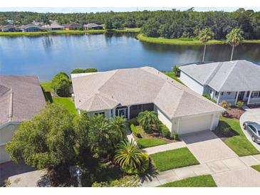 Beautiful lakefront property with lush landscaping and a well-maintained exterior at 201 Largo Dr, Kissimmee, FL 34759