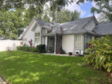 Charming single-Gathering home featuring a well-manicured lawn, lush landscaping, and inviting curb appeal at 2225 Maryday Ct, Orlando, FL 32812