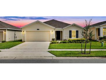 Charming single-story home featuring a manicured lawn and a two-car garage with great curb appeal at 4492 Bluff Oak Loop, Kissimmee, FL 34746