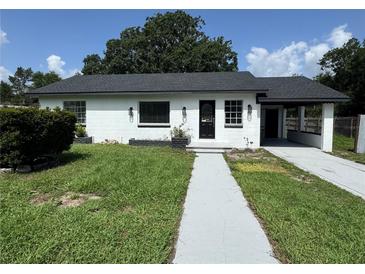 Charming single-story home with a covered front entrance and well-maintained lawn at 793 N Kentucky Ave, Umatilla, FL 32784