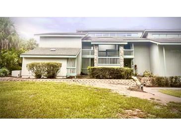Charming multi-level home featuring stone accents, covered balcony, and lush landscaping at 806 Pinewood Ct # 3135/6, Haines City, FL 33844
